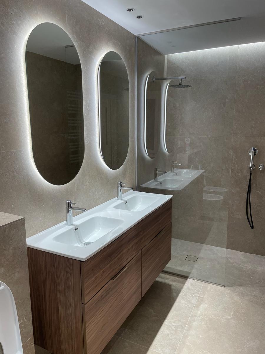 Baño con doble lavabo y espejos iluminados